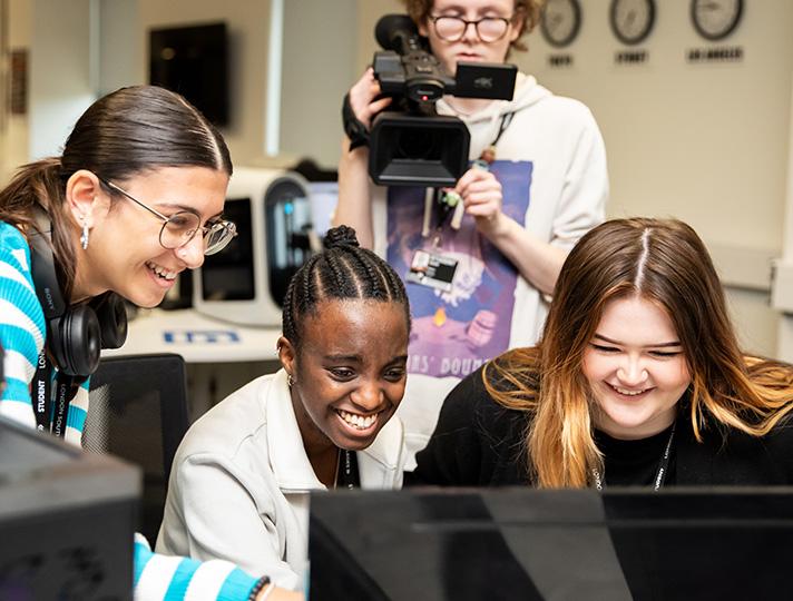 Students at a computer in the Media Suite