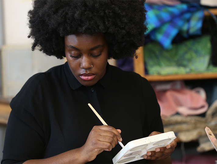 student working at desk in art studio