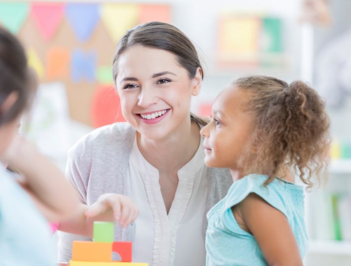 Student looking after young children in nursery setting