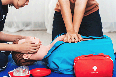 Students performing first aid on model