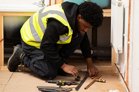 Student working in the plumbing workshop